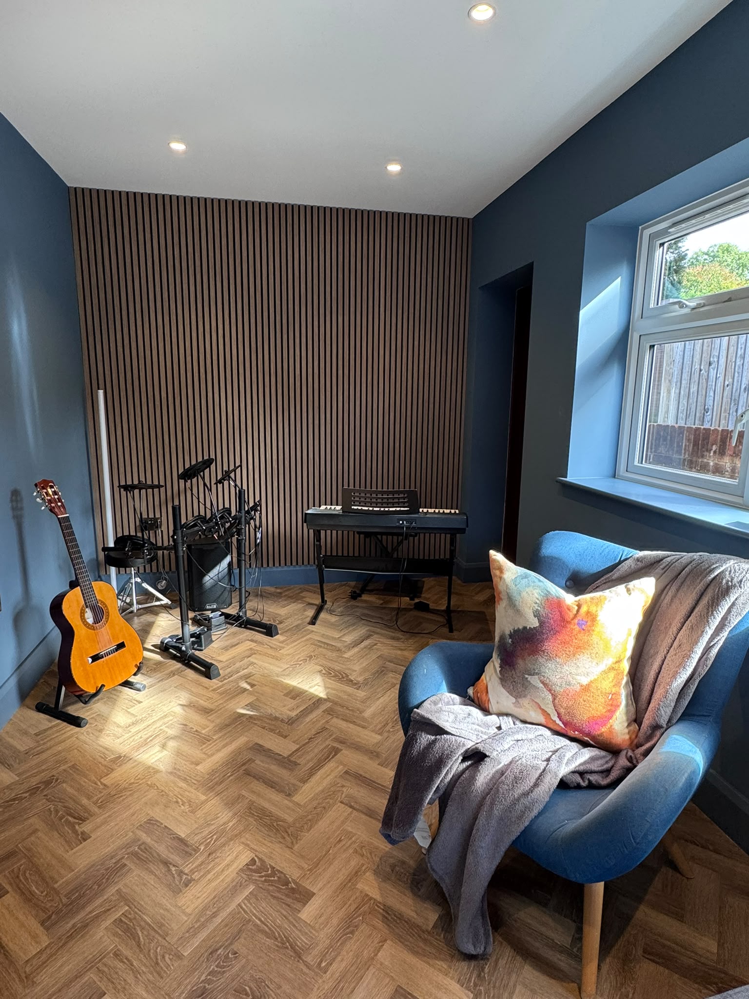 Music room with warm wood-effect floor